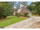 Brick home with attached garage on a lush lot with mature landscaping at 108 Summit Walk, Peachtree City, GA 30269