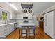 Bright kitchen featuring white cabinets, stainless steel appliances, and hardwood floors at 108 Summit Walk, Peachtree City, GA 30269