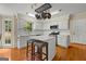 Kitchen featuring white cabinets, hardwood floors, stainless steel appliances, and center island at 108 Summit Walk, Peachtree City, GA 30269