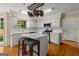 Bright kitchen with island, white cabinets, stainless steel appliances, hardwood floors and large window overlooking the backyard at 108 Summit Walk, Peachtree City, GA 30269