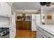 Spacious kitchen featuring stainless steel appliances, white cabinets, and hardwood floors at 108 Summit Walk, Peachtree City, GA 30269
