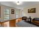 Living room showcasing hardwood floors, two windows for natural light, and stylish leather seating at 108 Summit Walk, Peachtree City, GA 30269