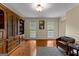 Living room with hardwood floors, stylish leather chair, and custom built-in bookcase at 108 Summit Walk, Peachtree City, GA 30269
