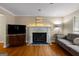 Inviting living room featuring a fireplace, hardwood floors, and natural light at 108 Summit Walk, Peachtree City, GA 30269
