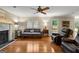 Cozy living room with hardwood floors, fireplace, and comfortable seating arrangement at 108 Summit Walk, Peachtree City, GA 30269
