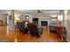 Open living room with hardwood floors, fireplace, and seamless flow into the dining area at 108 Summit Walk, Peachtree City, GA 30269