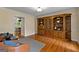 Cozy living room with hardwood floors, leather chairs, and custom built-in bookcase perfect for comfortable living and storage at 108 Summit Walk, Peachtree City, GA 30269