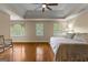 Spacious primary bedroom boasts hardwood floors, tray ceiling, ceiling fan, and large windows at 108 Summit Walk, Peachtree City, GA 30269