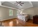 Spacious bedroom with hardwood floors, two windows, and a stylish ceiling fan, creating a serene and inviting atmosphere at 108 Summit Walk, Peachtree City, GA 30269