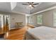 Bright primary bedroom features hardwood flooring, tray ceiling, and a cozy seating area at 108 Summit Walk, Peachtree City, GA 30269