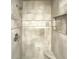 Modern shower with grey tile and a built-in niche at 108 Summit Walk, Peachtree City, GA 30269