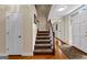 Classic staircase with hardwood and carpeted steps leading to the upper level, blending style and functionality at 108 Summit Walk, Peachtree City, GA 30269