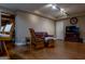 Finished basement offers a seating area with hardwood flooring, comfortable seating, and recessed track lighting at 8035 Magnolia Way, Roswell, GA 30075