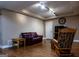 Finished basement offers a seating area with hardwood flooring, comfortable seating, and track lighting at 8035 Magnolia Way, Roswell, GA 30075