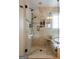 Bathroom featuring a glass shower with a built-in shower caddy, elegant tiling, and an oval soaking tub nearby at 8035 Magnolia Way, Roswell, GA 30075