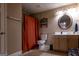Neutral toned bathroom featuring a toilet, vanity, lighting, mirror, shower and decor at 8035 Magnolia Way, Roswell, GA 30075
