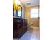 Charming bathroom with a dark wood vanity, granite countertop, sleek fixtures, and neutral tiling at 8035 Magnolia Way, Roswell, GA 30075
