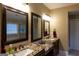 Bathroom with double sink vanity, granite countertops, and framed mirrors at 8035 Magnolia Way, Roswell, GA 30075