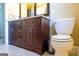 Stylish bathroom with a dark wood vanity, granite countertop, sleek fixtures, and neutral tiling at 8035 Magnolia Way, Roswell, GA 30075