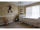 Bedroom has a rocking chair, white dresser, and a bed, with a window providing ample natural light at 8035 Magnolia Way, Roswell, GA 30075