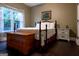 Inviting bedroom featuring a decorative bed, natural light, and warm colored hardwood flooring at 8035 Magnolia Way, Roswell, GA 30075