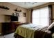 A bedroom featuring matching furniture, including a dresser and bedframe, enhanced by natural light from a window at 8035 Magnolia Way, Roswell, GA 30075