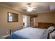 Comfortable bedroom features a ceiling fan, window, decorative mirror, and wood dresser at 8035 Magnolia Way, Roswell, GA 30075