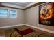 Empty bonus room with hardwood floors, two windows with blinds, and ceiling trim at 8035 Magnolia Way, Roswell, GA 30075