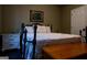 Comfortable bedroom with a decorative bed frame, white comforter with embroidery, and warm lighting at 8035 Magnolia Way, Roswell, GA 30075