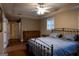 Comfortable bedroom features a ceiling fan, window, decorative mirror, and wood dresser at 8035 Magnolia Way, Roswell, GA 30075