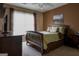 This bedroom has a wooden-framed bed, matching dressers, and a window, offering a cozy and functional space at 8035 Magnolia Way, Roswell, GA 30075