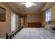 Comfortable bedroom features a ceiling fan, window, decorative mirror, and wood dresser at 8035 Magnolia Way, Roswell, GA 30075