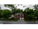 Wide shot of a brick home showcasing its curb appeal and landscaping at 8035 Magnolia Way, Roswell, GA 30075