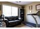 Versatile flex space featuring a comfortable love seat, treadmill, natural light, and neutral paint at 8035 Magnolia Way, Roswell, GA 30075