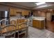 Well-lit eat-in kitchen is equipped with tile flooring, stainless steel appliances, and wooden cabinets at 8035 Magnolia Way, Roswell, GA 30075