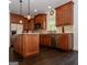 Beautiful kitchen featuring stainless steel appliances, granite countertops, and dark wood cabinets at 8035 Magnolia Way, Roswell, GA 30075