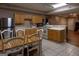 Well-lit eat-in kitchen is equipped with tile flooring, stainless steel appliances, and wooden cabinets at 8035 Magnolia Way, Roswell, GA 30075