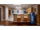 Basement kitchenette has bar-style seating with an open doorway leading to another finished basement space at 8035 Magnolia Way, Roswell, GA 30075