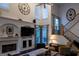 Cozy living room offers a fireplace, staircase, and large windows for natural light at 8035 Magnolia Way, Roswell, GA 30075