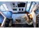 Top-down view of the living room boasts fireplace, staircase, and leather sectional at 8035 Magnolia Way, Roswell, GA 30075