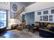 Bright, open living room features a large window, staircase, and hardwood floors at 8035 Magnolia Way, Roswell, GA 30075