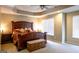 Bedroom features a large wooden bed, tray ceiling, and neutral carpet at 8035 Magnolia Way, Roswell, GA 30075