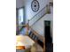 Bright staircase with wooden banister, black iron spindles and carpeted steps at 8035 Magnolia Way, Roswell, GA 30075