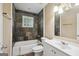 Bathroom featuring a bath tub with shower, vanity and tiled wall at 1854 Shadydale Se Ave, Atlanta, GA 30315