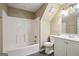 Bright bathroom featuring a shower-tub combo, white vanity, and neutral wall colors at 1854 Shadydale Se Ave, Atlanta, GA 30315