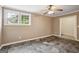Bedroom with stone tile flooring, ceiling fan, and two windows at 1854 Shadydale Se Ave, Atlanta, GA 30315