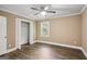 Bedroom with wood-look floors, a ceiling fan, a window, and a closet at 1854 Shadydale Se Ave, Atlanta, GA 30315