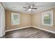 Bedroom with wood-look floors, ceiling fan, and two windows at 1854 Shadydale Se Ave, Atlanta, GA 30315