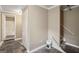 Hallway with stone tile flooring leading to a bathroom and staircase at 1854 Shadydale Se Ave, Atlanta, GA 30315