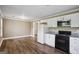 Bright kitchen with white cabinets, black appliances and wood flooring at 1854 Shadydale Se Ave, Atlanta, GA 30315